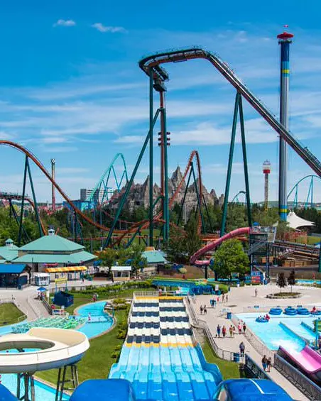 An amusement park filled with water slides, roller coasters and free fall rides.